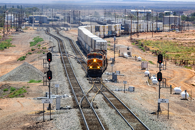 A westbound intermodal train departs Winslow from one of the new tracks. A westbound intermodal train departs Winslow from one of the new tracks.